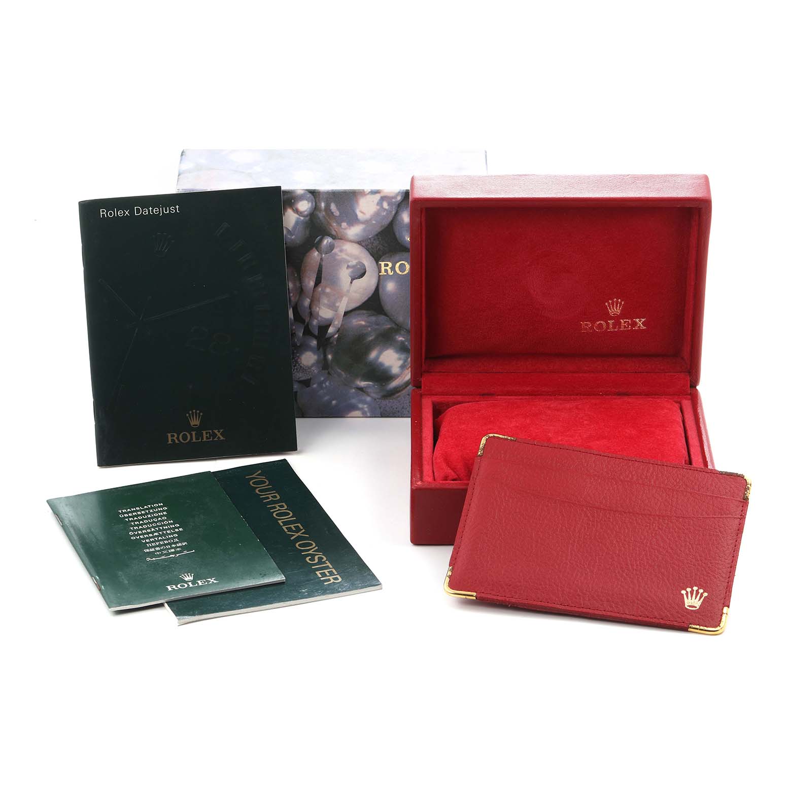 The image shows the packaging and documents for a Rolex Datejust model 69174, including a red box, card holder, and manuals.