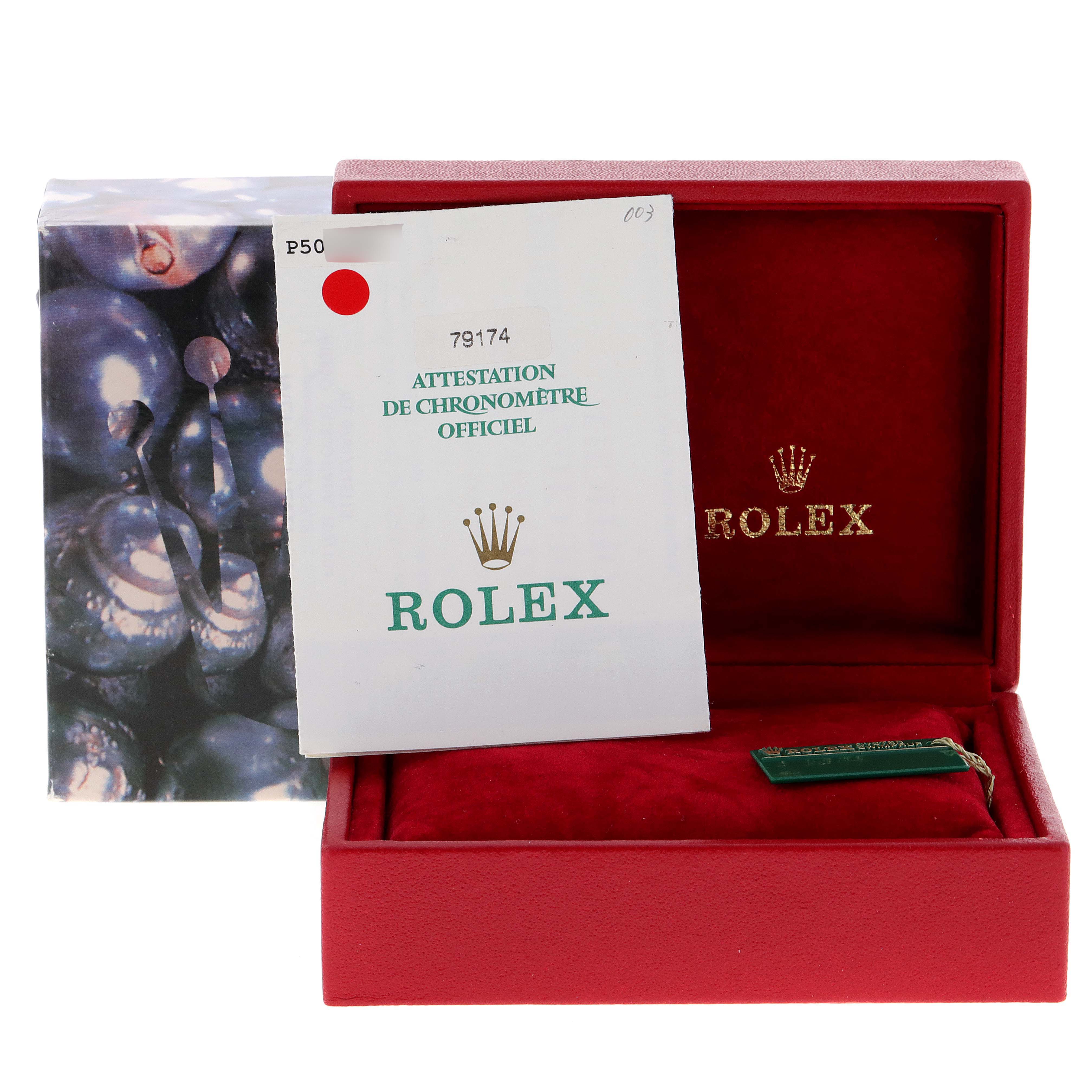 The image shows a red Rolex box with paperwork and a green tag for the Datejust model.