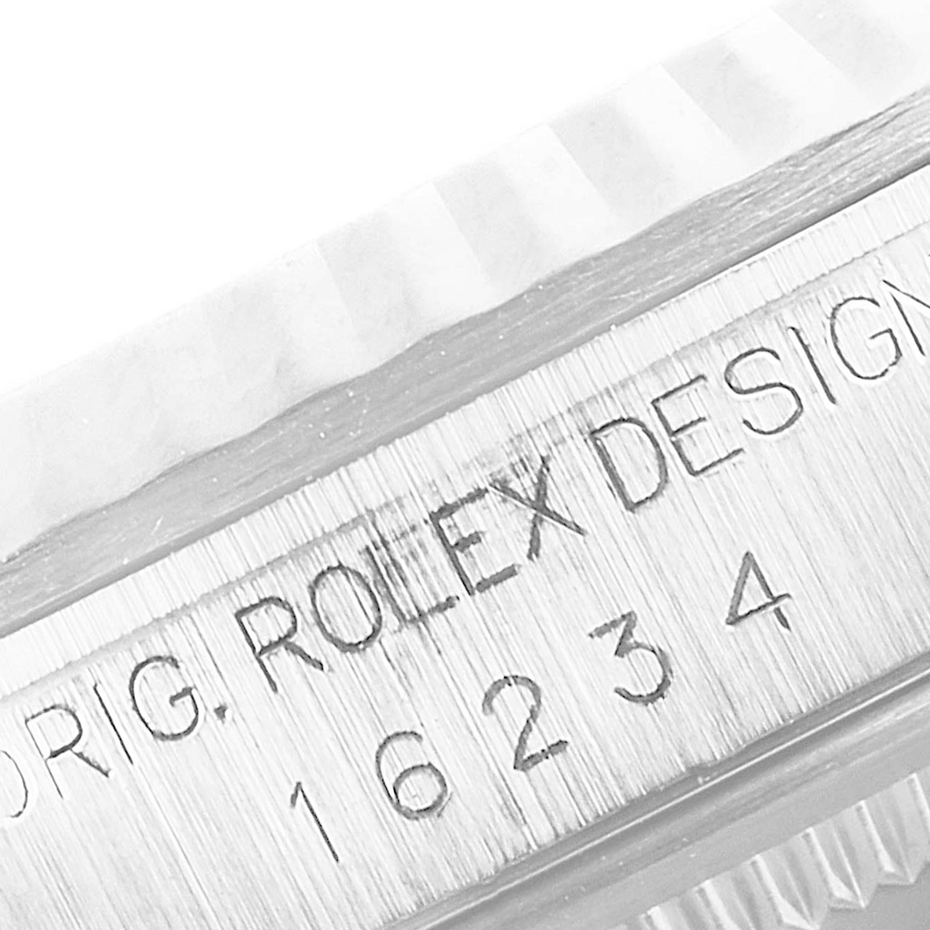 Close-up of the bezel and side engraving on the Rolex Datejust 16234 Men's Stainless Steel Silver Dial 16234 Men's Stainless Steel Silver Dial model, showing "ORIG. ROLEX DESIGN 16234."