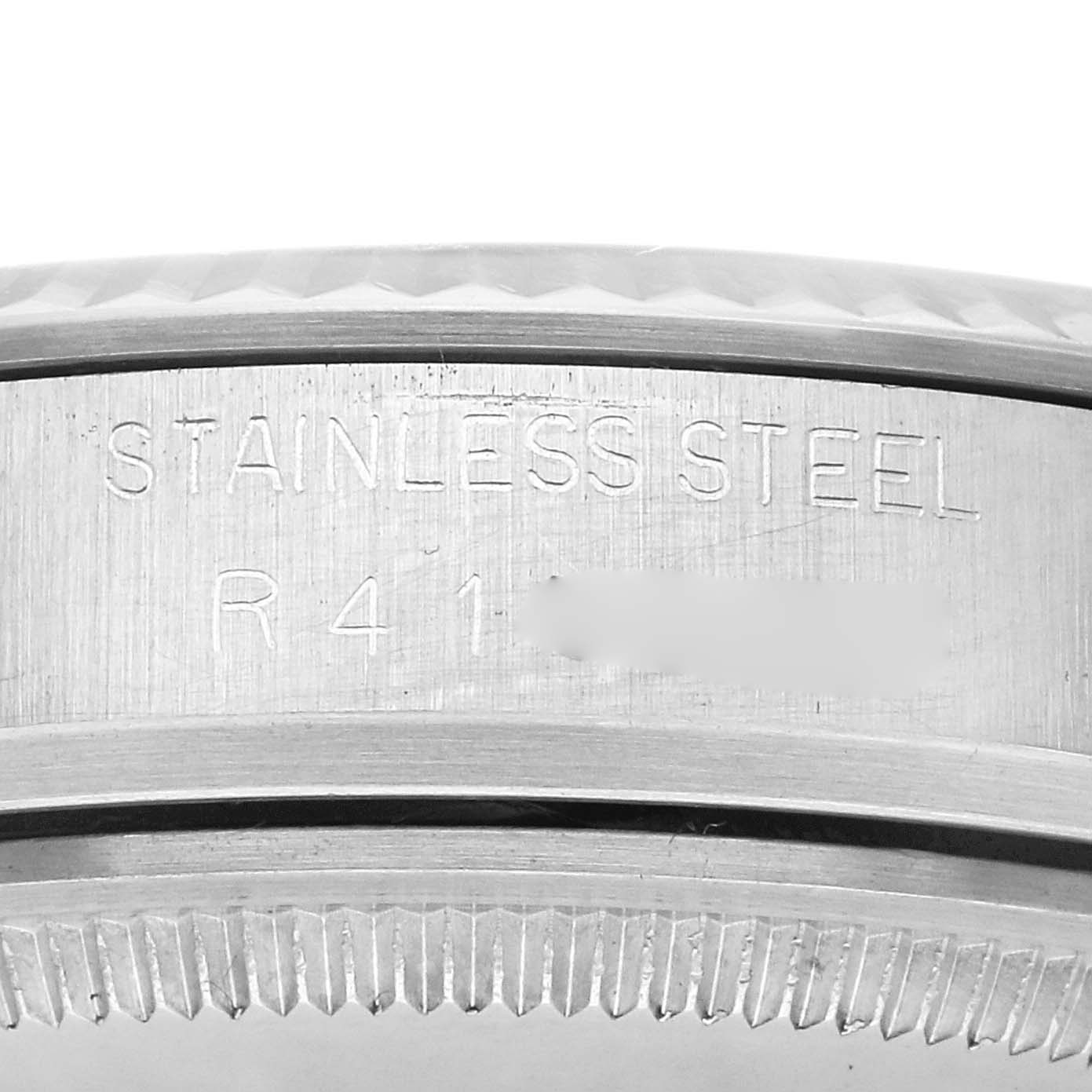 The image shows a close-up of the side of a Rolex Vintage Collection model, model number 16014, focusing on the stainless steel engraving.