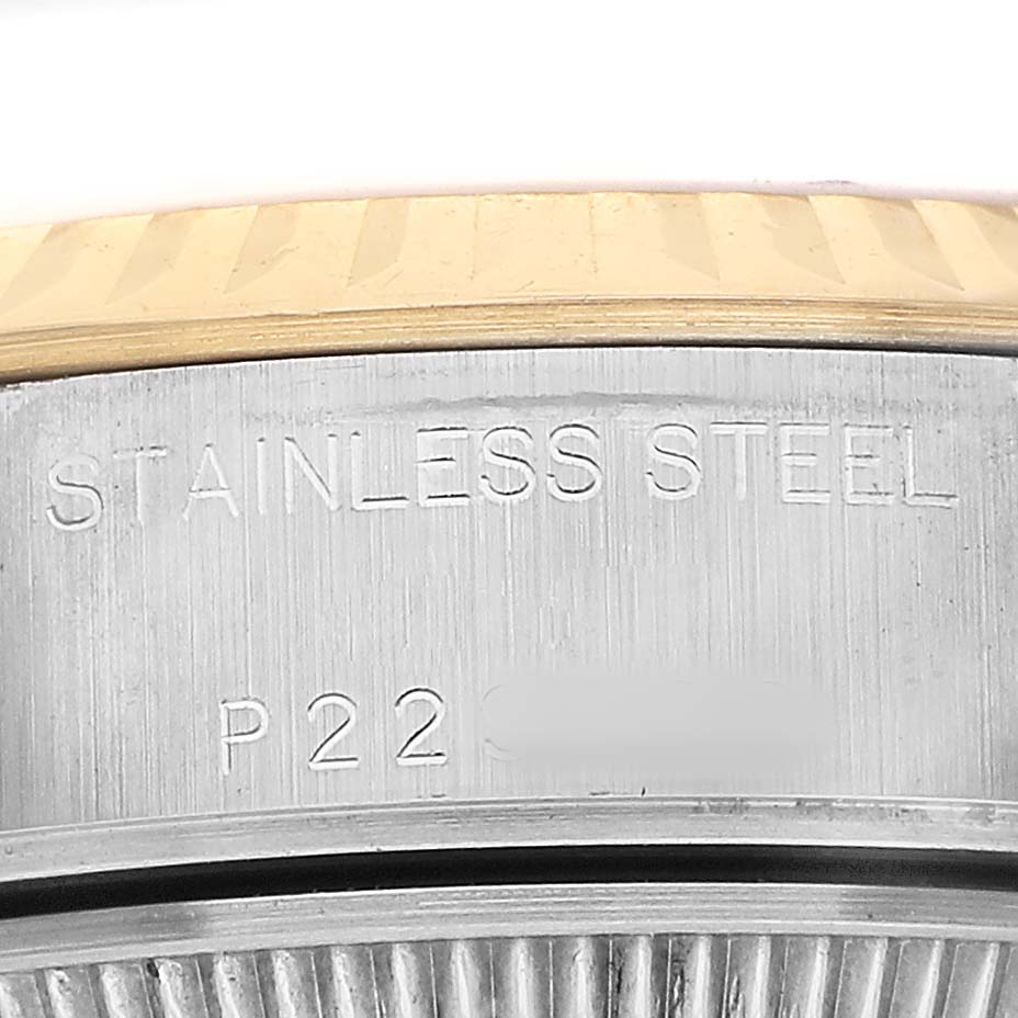 The image shows a close-up of the side of a Rolex Datejust 79173 Women's Stainless Steel Champagne Dial watch, specifically the stainless steel casing with some engraved details.