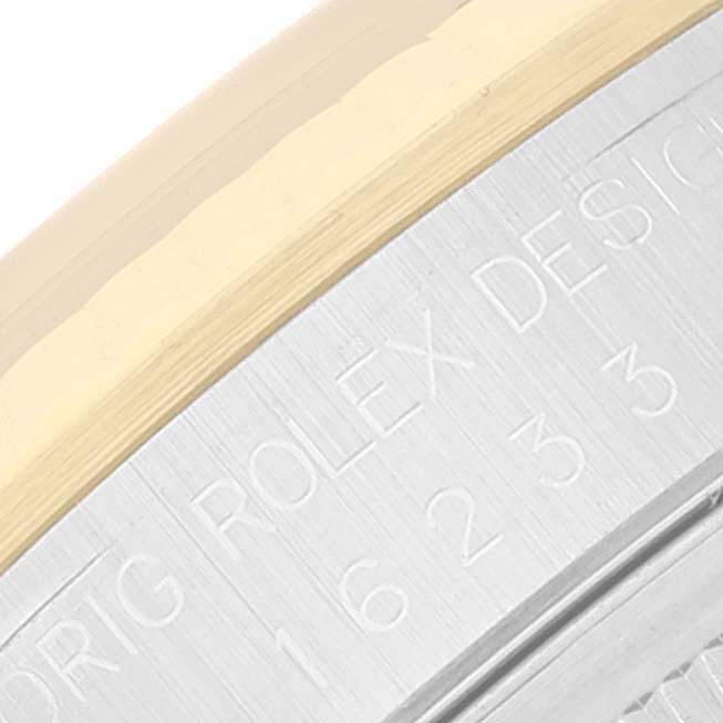 This close-up image shows the engraved model number and the bezel of a Rolex Datejust 16233 Men's Steel and Gold (two tone) Black Dial 16233 Men's Steel and Gold (two tone) Black Dial watch.