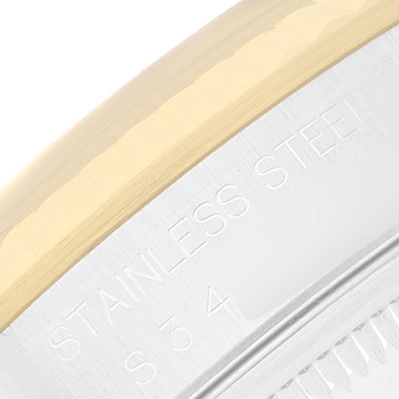 The image shows a close-up view of the stainless steel and gold bezel of a Rolex Datejust 16233 Men's Steel and Gold (two tone) Black Dial 16233 Men's Steel and Gold (two tone) Black Dial watch, including part of the engraved text “STAINLESS STEEL.”