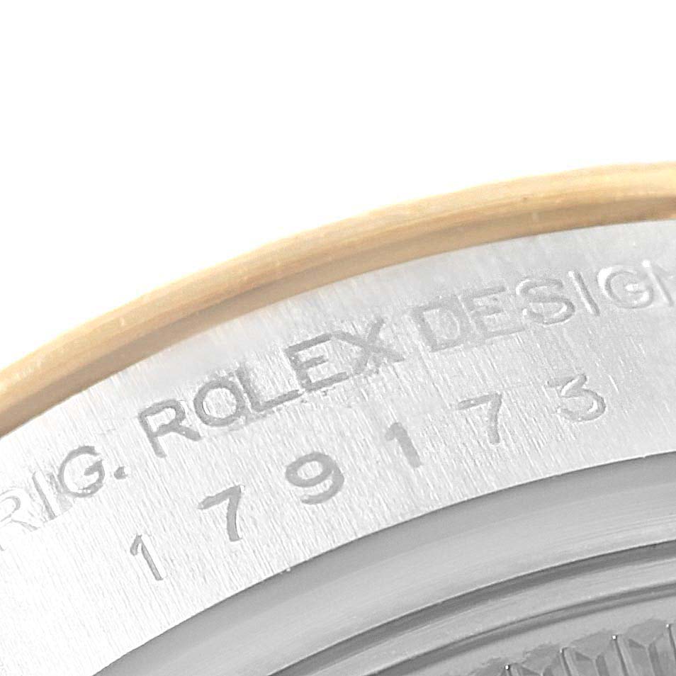 This image shows a close-up of the case back edge with engraving on a Rolex Datejust 179173 Women's Steel and Gold (two tone) Black Dial 179173 Women's Steel and Gold (two tone) Black Dial watch.
