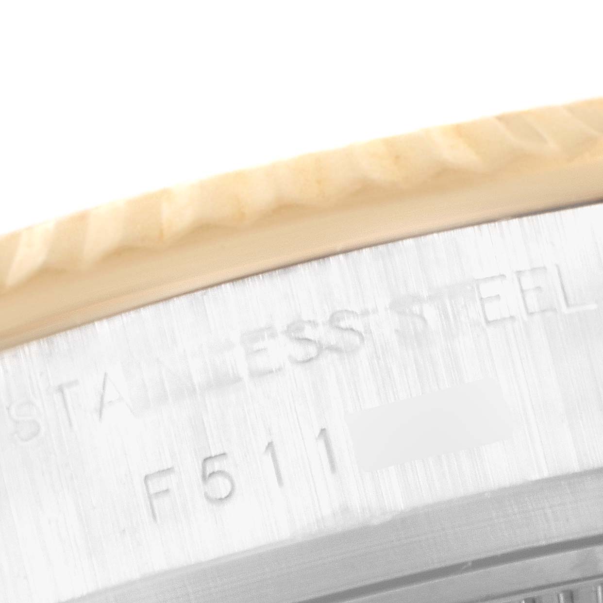 This close-up image shows the side engraving and part of the bezel on a Rolex Datejust 179173 Women's Steel and Gold (two tone) Black Dial 179173 Women's Steel and Gold (two tone) Black Dial watch.