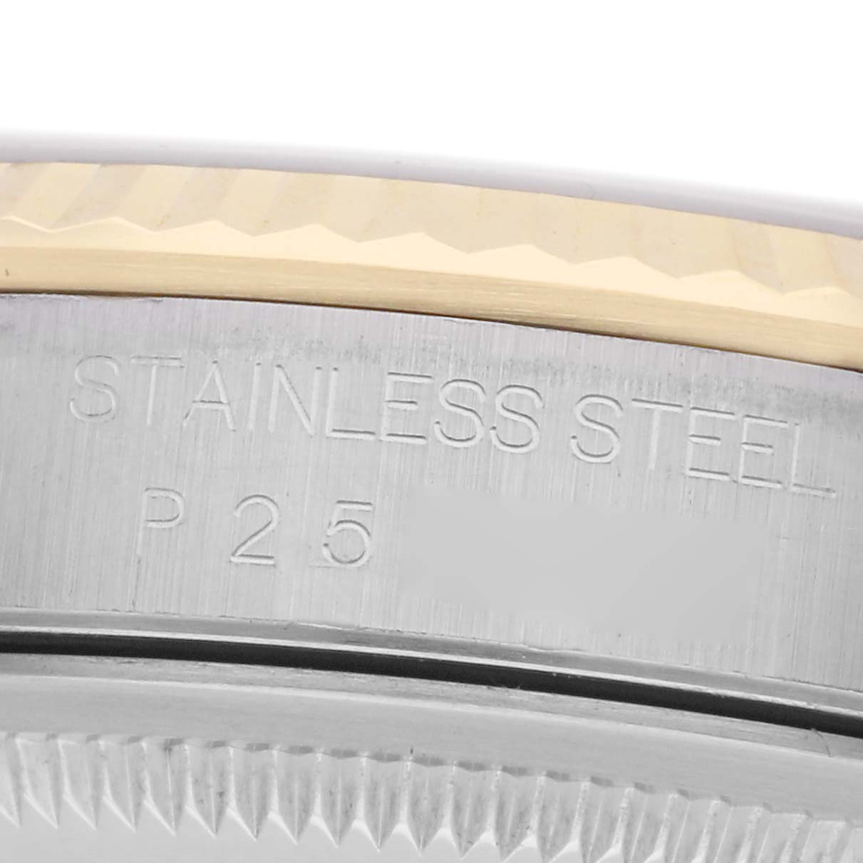 The image shows an angled close-up of the stainless steel and gold bezel edge on the Rolex Datejust model 16233 men
s watch, highlighting the material engraving.