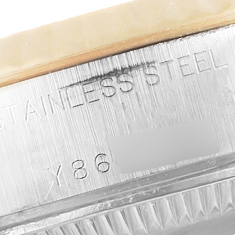 This close-up image shows the edge of the bezel and part of the casing of the Rolex Datejust 79173 Women
s Steel and Gold (two tone) Silver Dial 79173 Women
s Steel and Gold (two tone) Silver Dial, with visible text etched on the stainless steel.