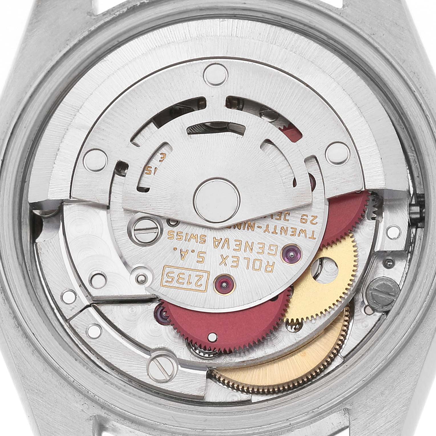 The image shows the movement of a Rolex Datejust 69173 Women's Stainless Steel White Dial watch, featuring gears and engravings, viewed from the back.