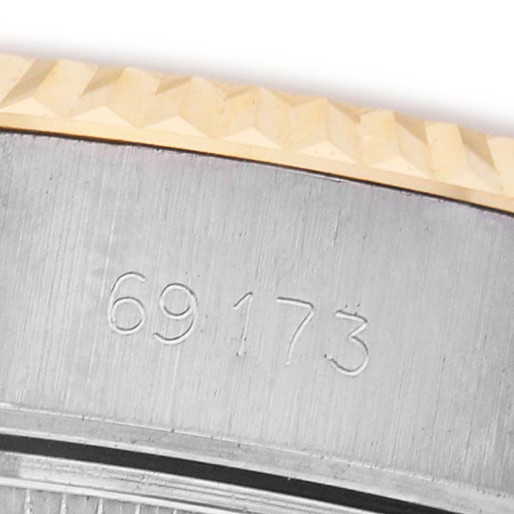 The image shows a close-up of the case side and fluted bezel of a Rolex Datejust 69173 Women's Stainless Steel White Dial, highlighting a serial number.