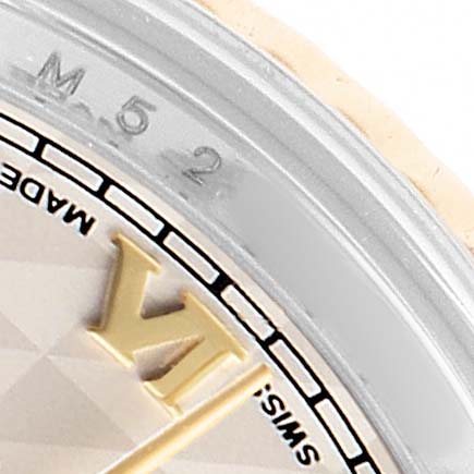 This close-up of the Rolex Datejust 179173 Women's Steel and Gold (two tone) White Dial highlights the edge of the dial, the Roman numeral VI, and part of the bezel.