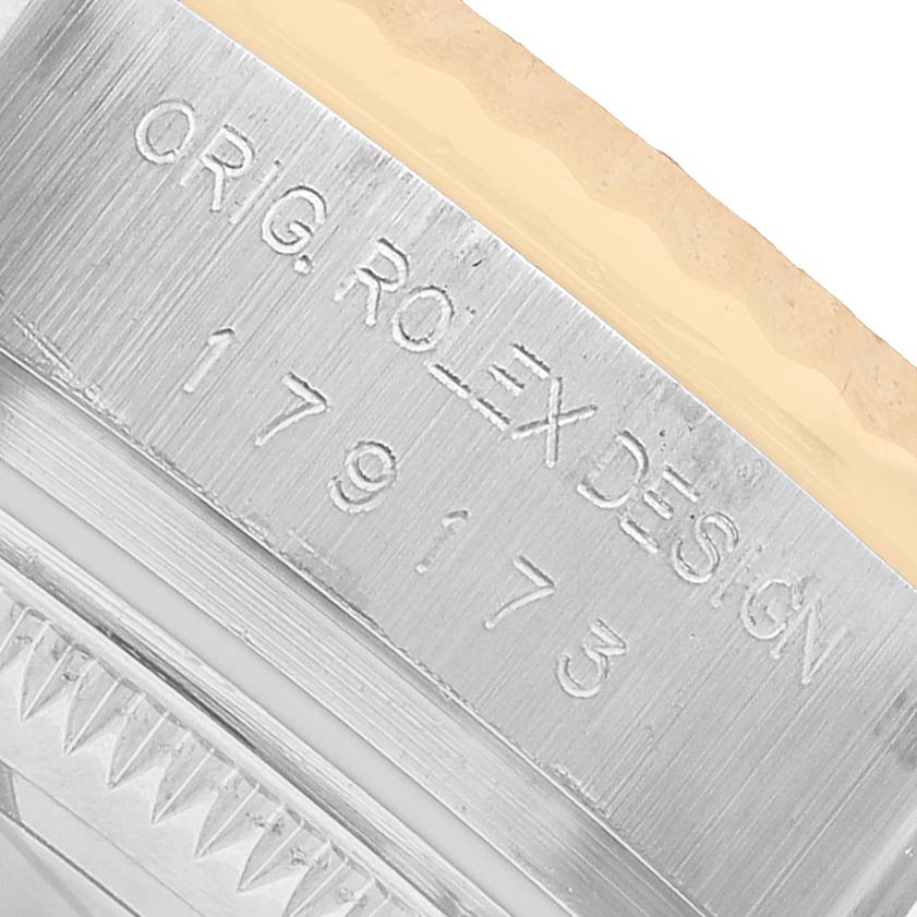 The image shows a close-up of the case side engraving on a Rolex Datejust 179173 Women's Steel and Gold (two tone) White Dial, highlighting the model number.