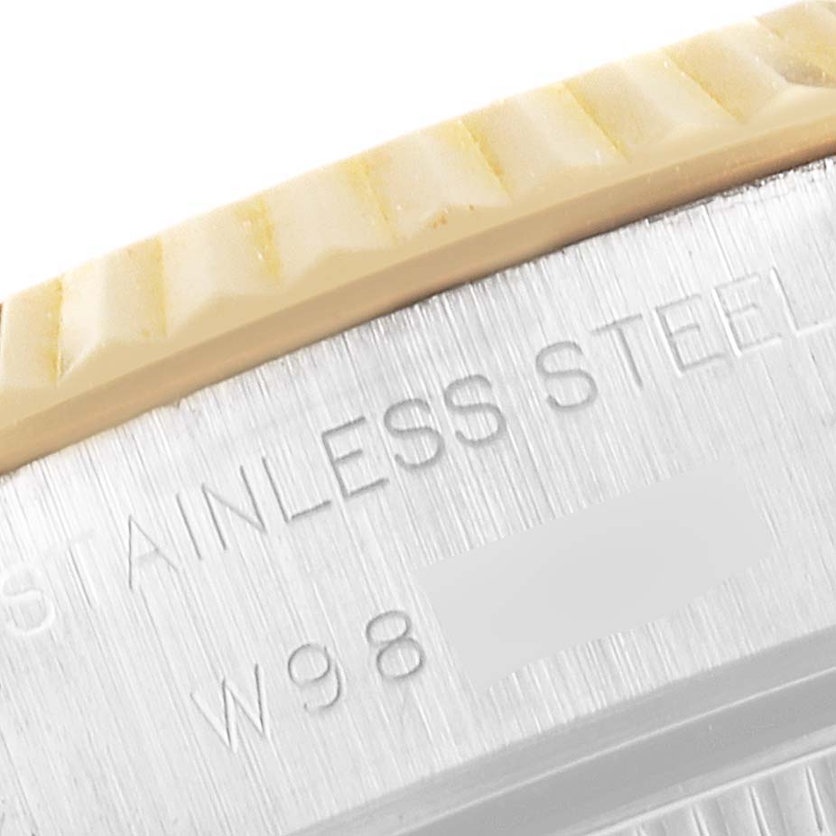 This close-up angle of the Rolex Datejust 69173 Women's Steel and Gold (two tone) Blue Dial 69173 Women's Steel and Gold (two tone) Blue Dial model shows part of the stainless steel case and fluted bezel.