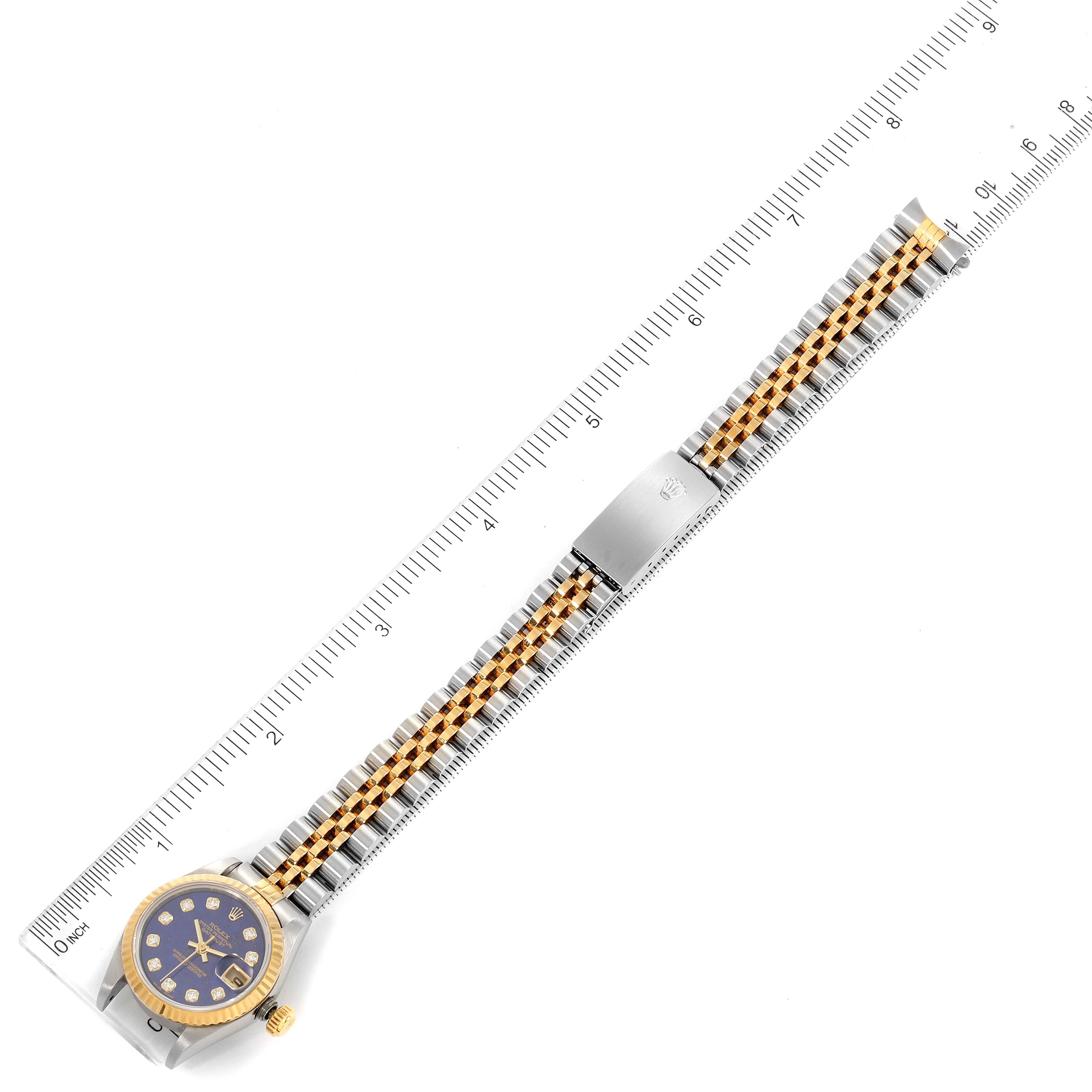 The image shows a top-down view of a Rolex Datejust 69173 Women's Steel and Gold (two tone) Blue Dial 69173 Women's Steel and Gold (two tone) Blue Dial watch with its band extended and a ruler beside it for scale.
