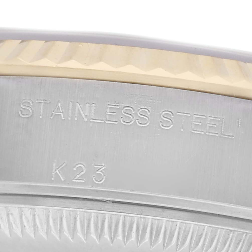 The image shows a close-up of the Rolex Datejust model 79173, highlighting the edge of the case with "STAINLESS STEEL" and "K23" engraved.