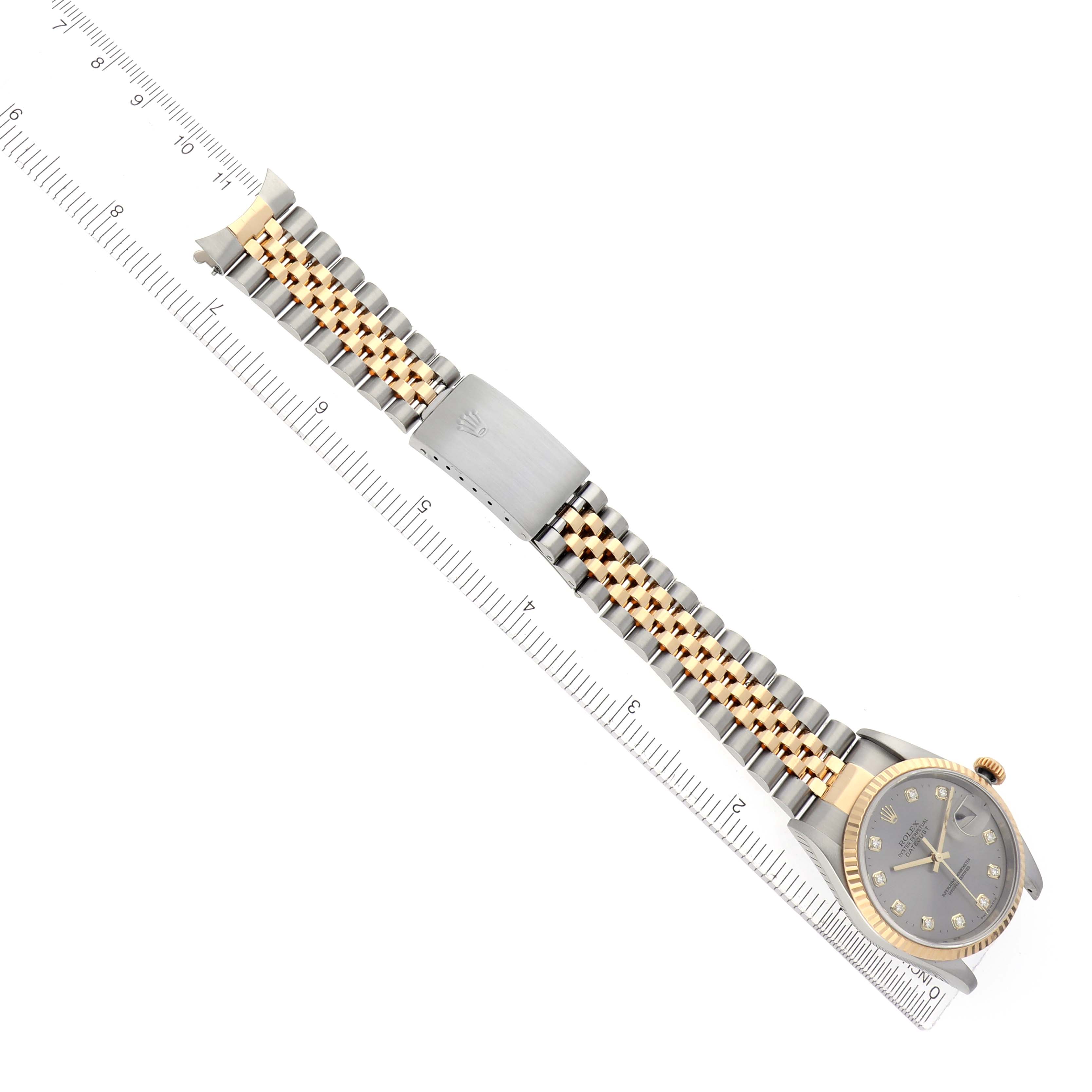 The image shows the Rolex Datejust model, number 16233, at a diagonal angle, featuring its gold and silver bracelet and diamond-accented dial.