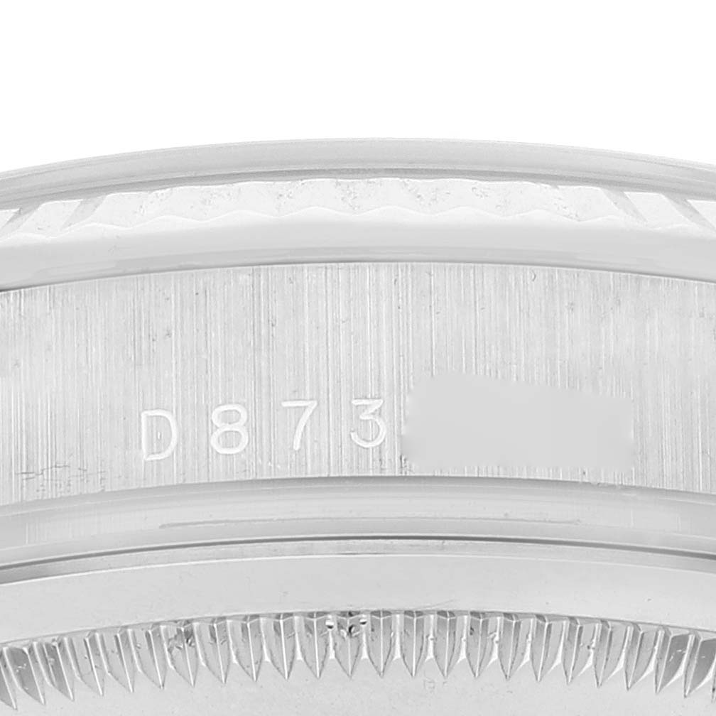 This image shows a close-up of the serial number area and the edge of the bezel of a Rolex President 118239 Men's White Gold Silver Dial 118239 Men's White Gold Silver Dial model watch.