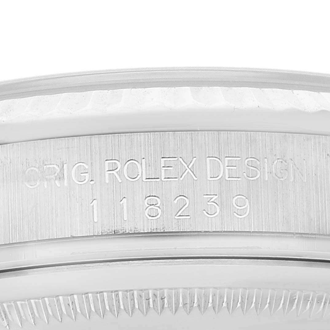 This close-up image shows the engraved text and serial number on the side of the bezel of a Rolex President 118239 Men's White Gold Silver Dial 118239 Men's White Gold Silver Dial model.