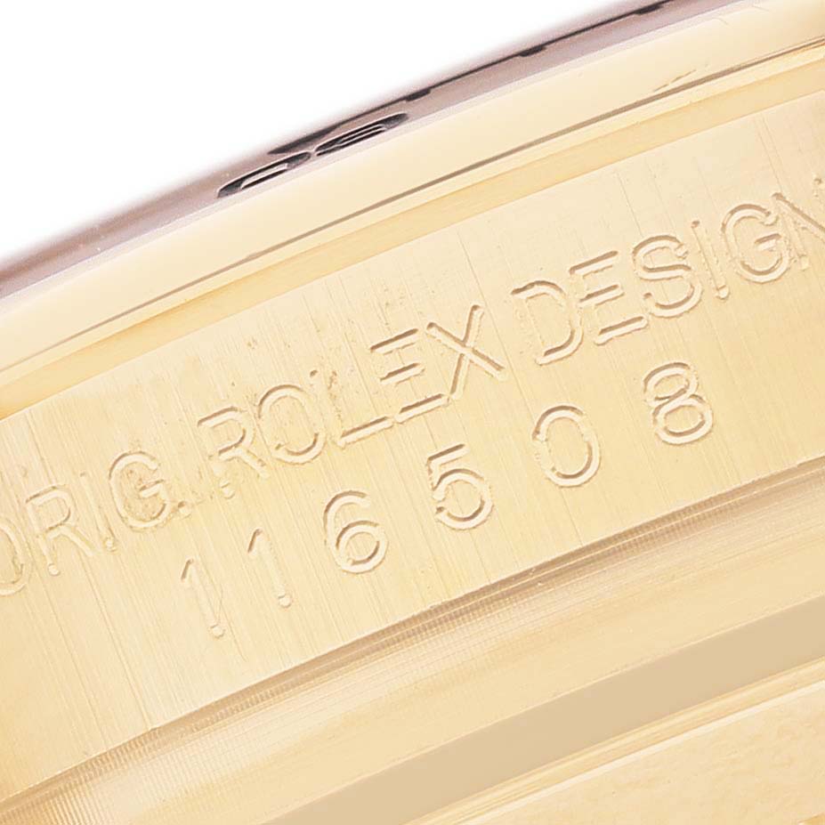The image shows a close-up of the side of a Rolex Daytona 116508 Men's Yellow Gold Black Dial watch case, featuring the engraved model number and branding details.