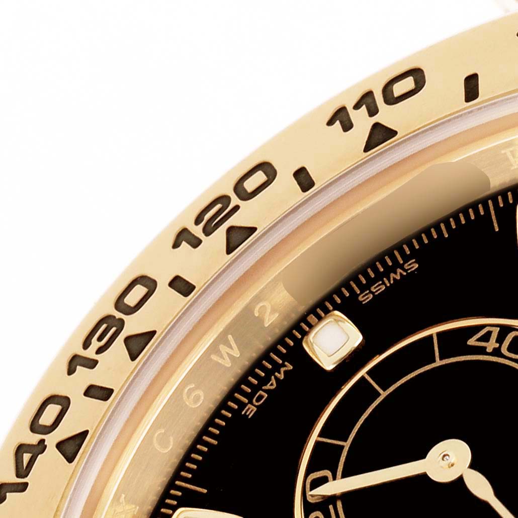 The image shows a close-up of the bezel and dial of a Rolex Daytona 116508 Men's Yellow Gold Black Dial, focusing on the tachymetric scale and part of the sub-dial.