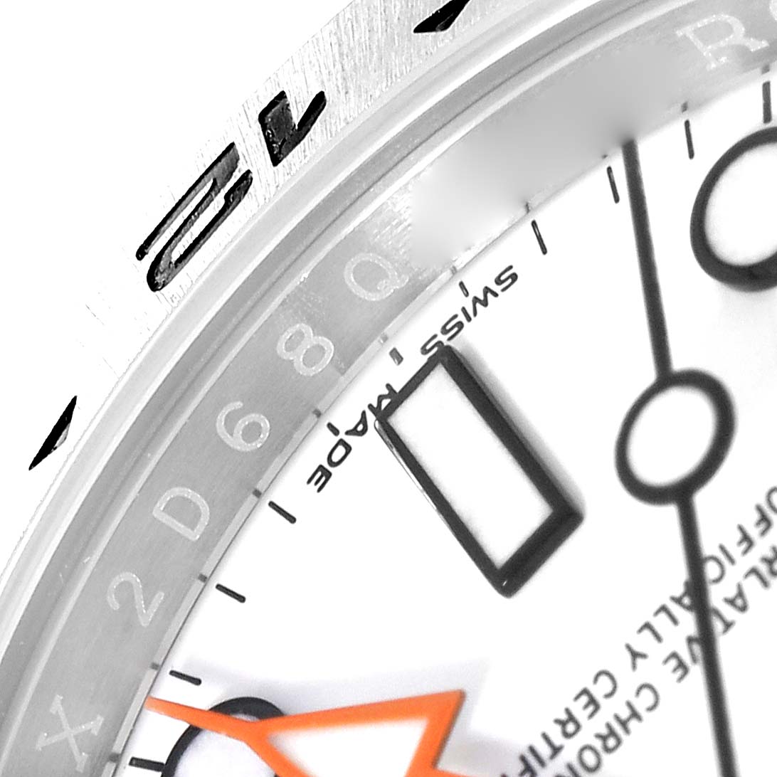 This is a close-up angled view of the Rolex Explorer 216570 Men
s Stainless Steel White Dial 216570 Men
s Stainless Steel White Dial watch showing part of the dial, markers, and bezel.