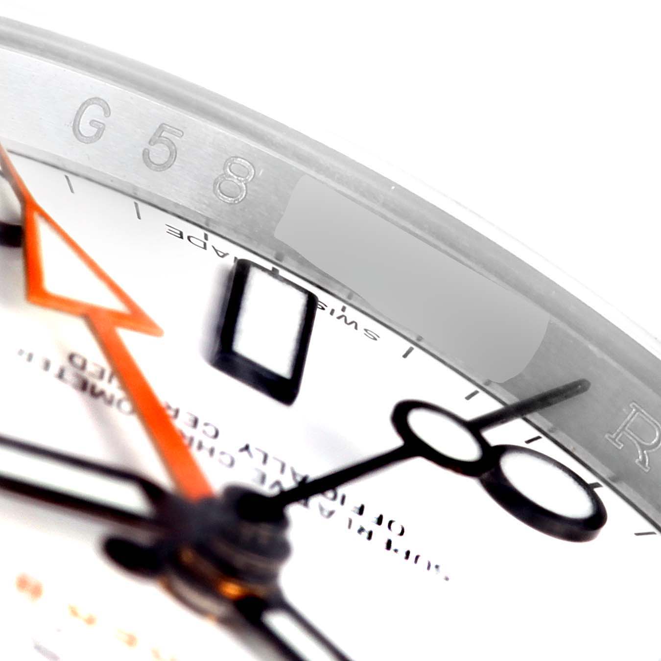 This close-up of a Rolex Explorer 216570 Men
s Stainless Steel White Dial 216570 Men
s Stainless Steel White Dial watch shows the dial, bezel, and hands, emphasizing details like the engraved serial number and hour markers.