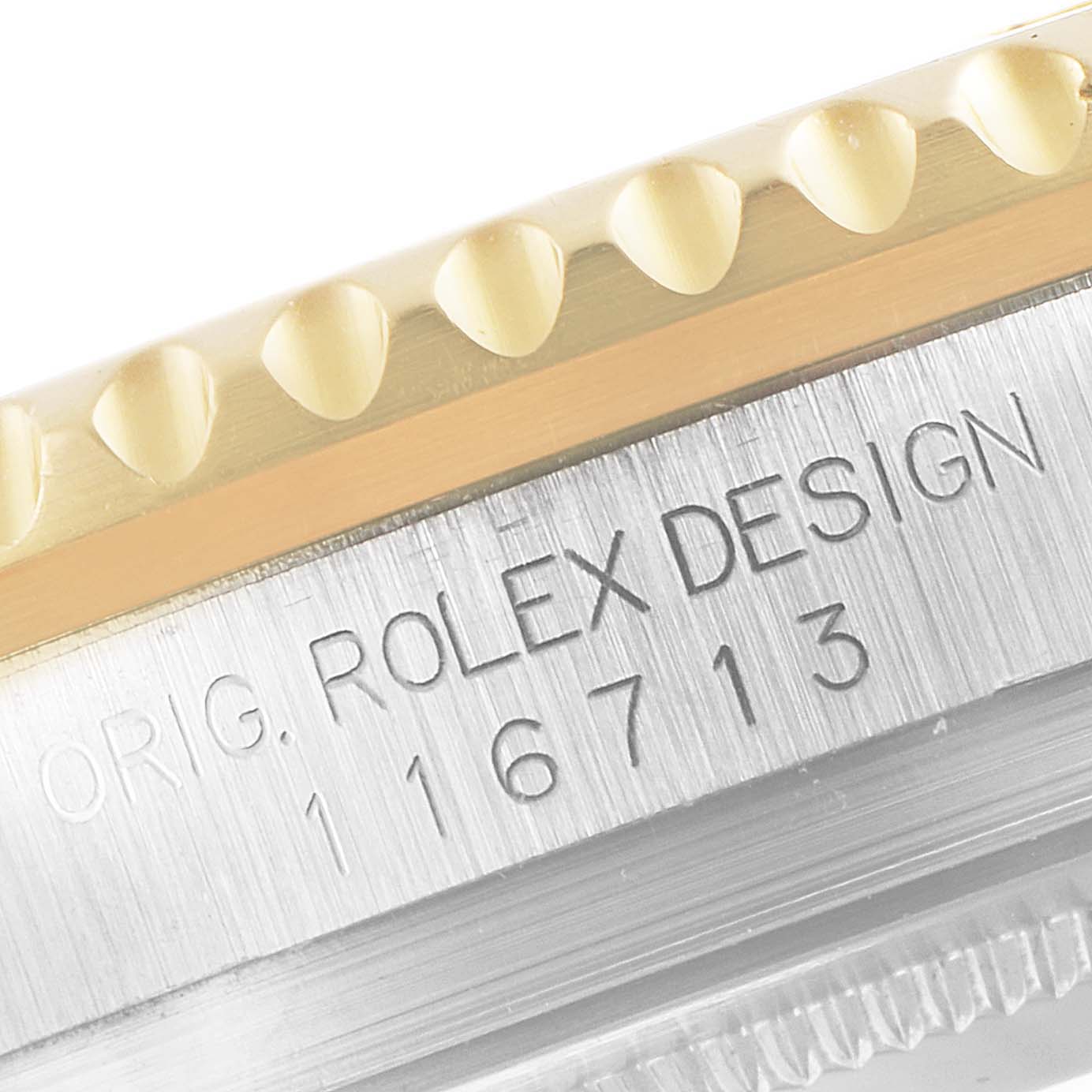 This is a close-up of the bezel and case side of a Rolex GMT-Master 116713 Men's Steel and Gold (two tone) Black Dial 116713 Men's Steel and Gold (two tone) Black Dial, showing engraved text and reference number.