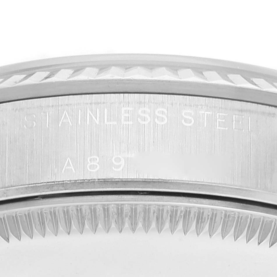 The image shows a close-up side view of a stainless steel case back and bezel of a Rolex Mid-Size 77014 Women's Stainless Steel Black Dial 77014 Women's Stainless Steel Black Dial model watch.