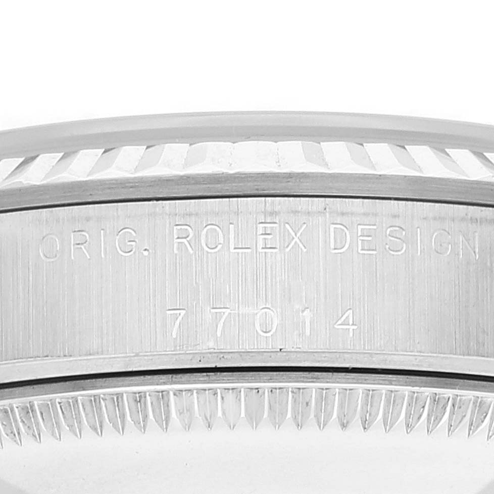 This close-up image shows the side of the mid-case and bezel of a Mid-Size Rolex watch, with engraved model numbers visible.