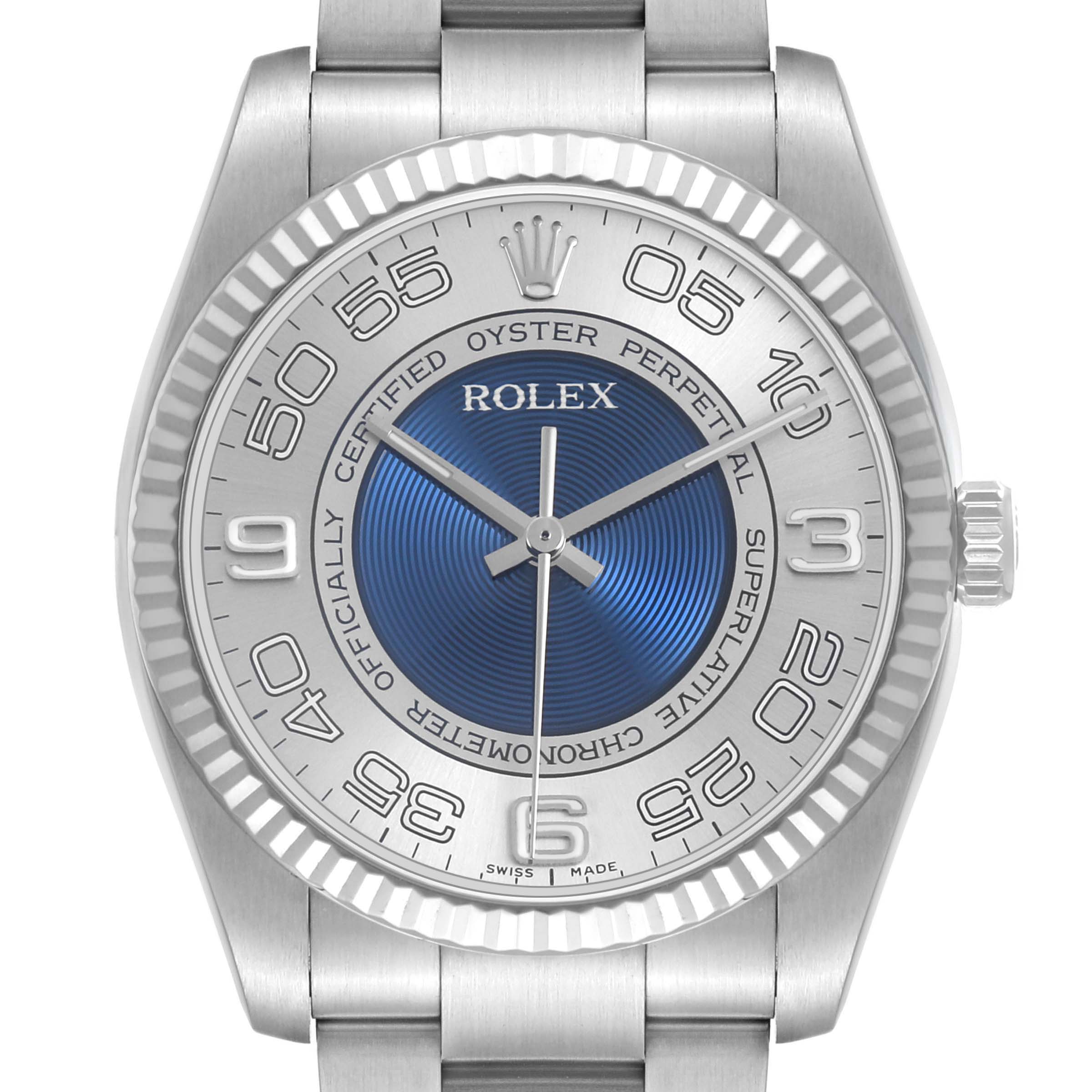 The Rolex Oyster Perpetual 116034 Men's Stainless Steel Blue Dial watch is shown from a front angle, displaying the dial, bezel, hands, and bracelet.