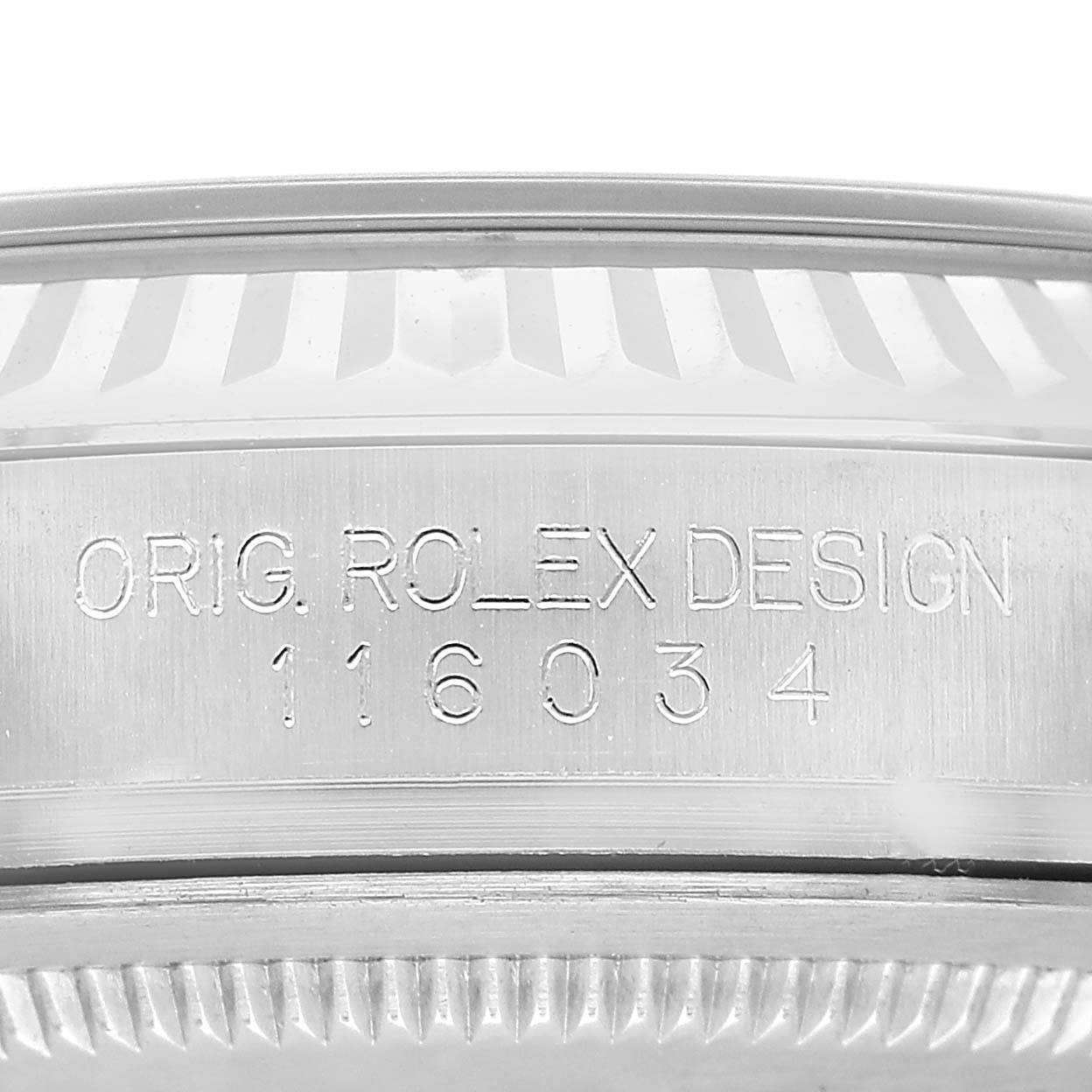The image shows a close-up of the side of a Rolex Oyster Perpetual 116034 Men's Stainless Steel Blue Dial watch, highlighting the engraved model number and design text.