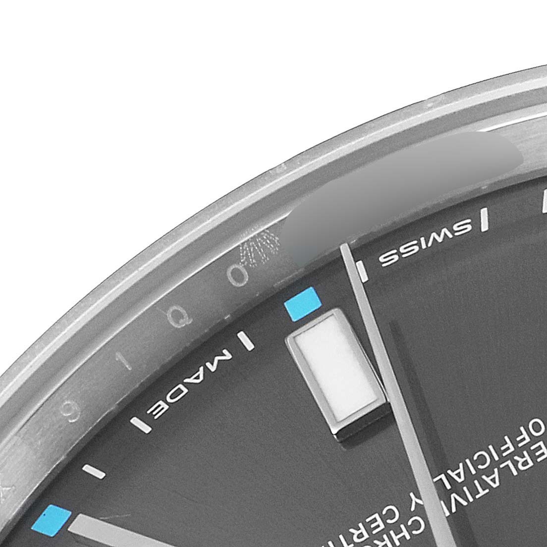 This image shows a close-up of the dial's edge and hour markers of a Rolex Oyster Perpetual 114300 Men's Stainless Steel Silver Dial 114300 Men's Stainless Steel Silver Dial watch, including the "SWISS" and "MADE" text.