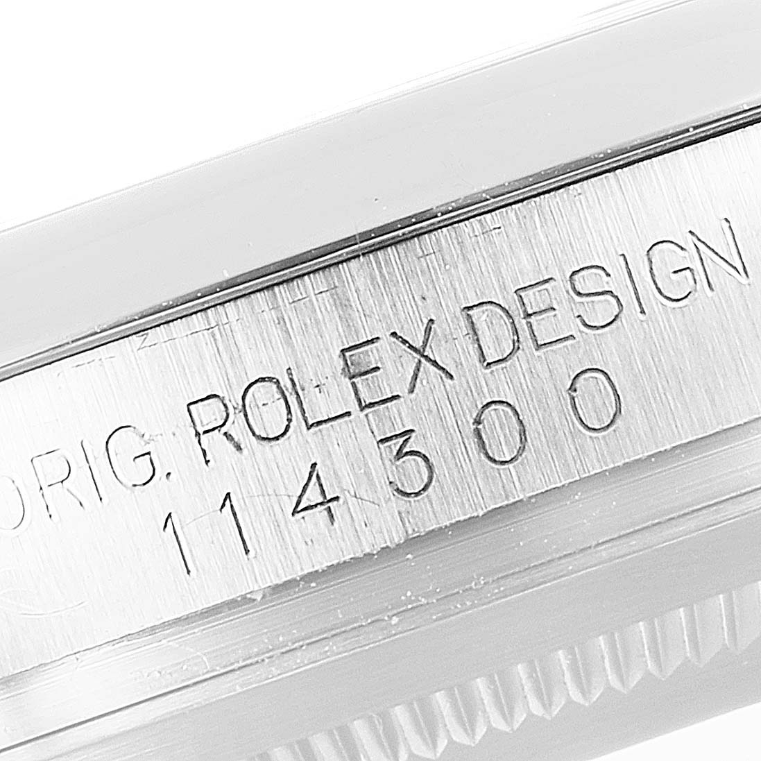 This image shows a close-up of the side of the casing of a Rolex Oyster Perpetual 114300 Men's Stainless Steel Silver Dial 114300 Men's Stainless Steel Silver Dial watch, displaying the branding and model number.