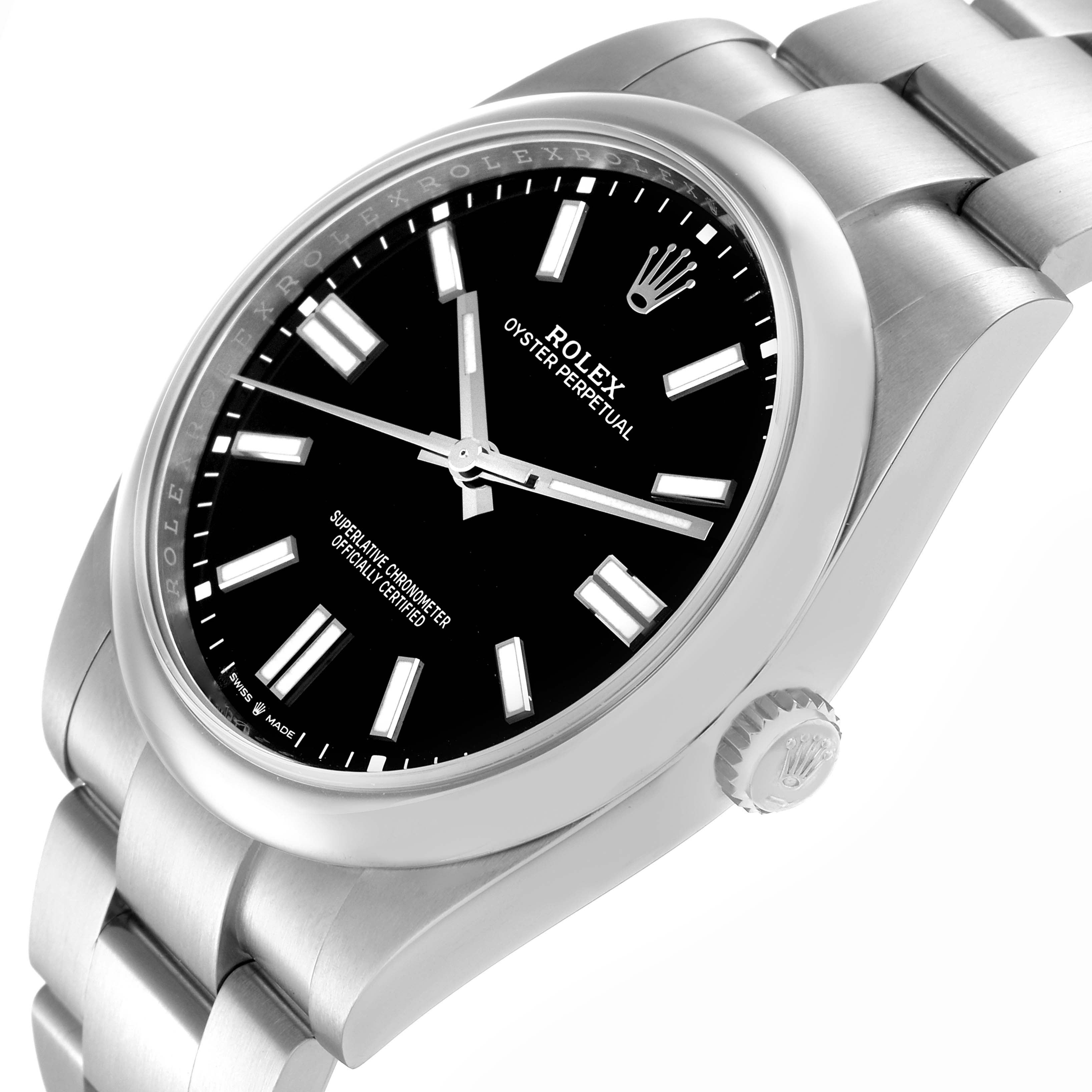 The image shows a Rolex Oyster Perpetual model 124300 watch from a high oblique angle, highlighting the face, bezel, crown, and part of the bracelet.