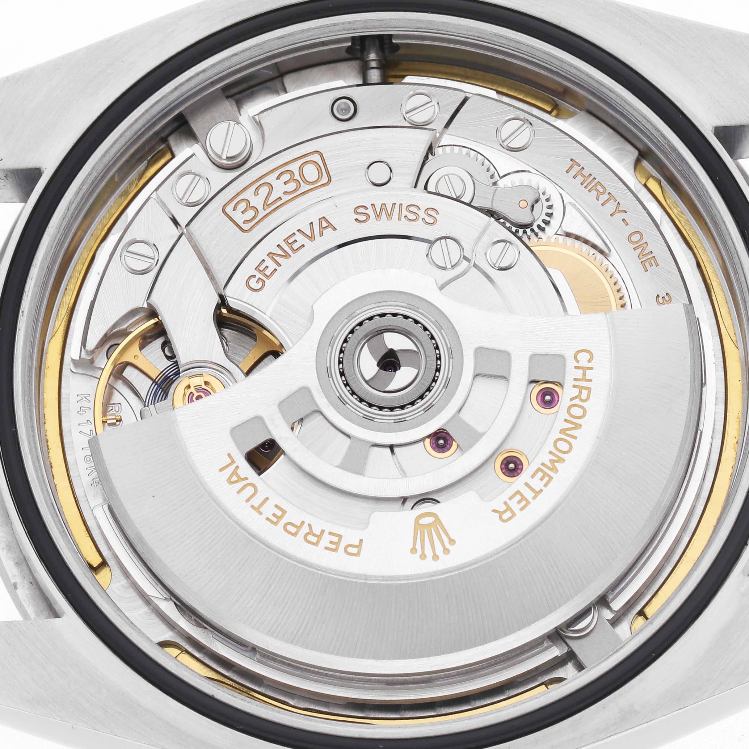 The image shows the back view of the Rolex Oyster Perpetual model 124300, highlighting its intricate movement and rotor engraved with "Perpetual" and "Chronometer."