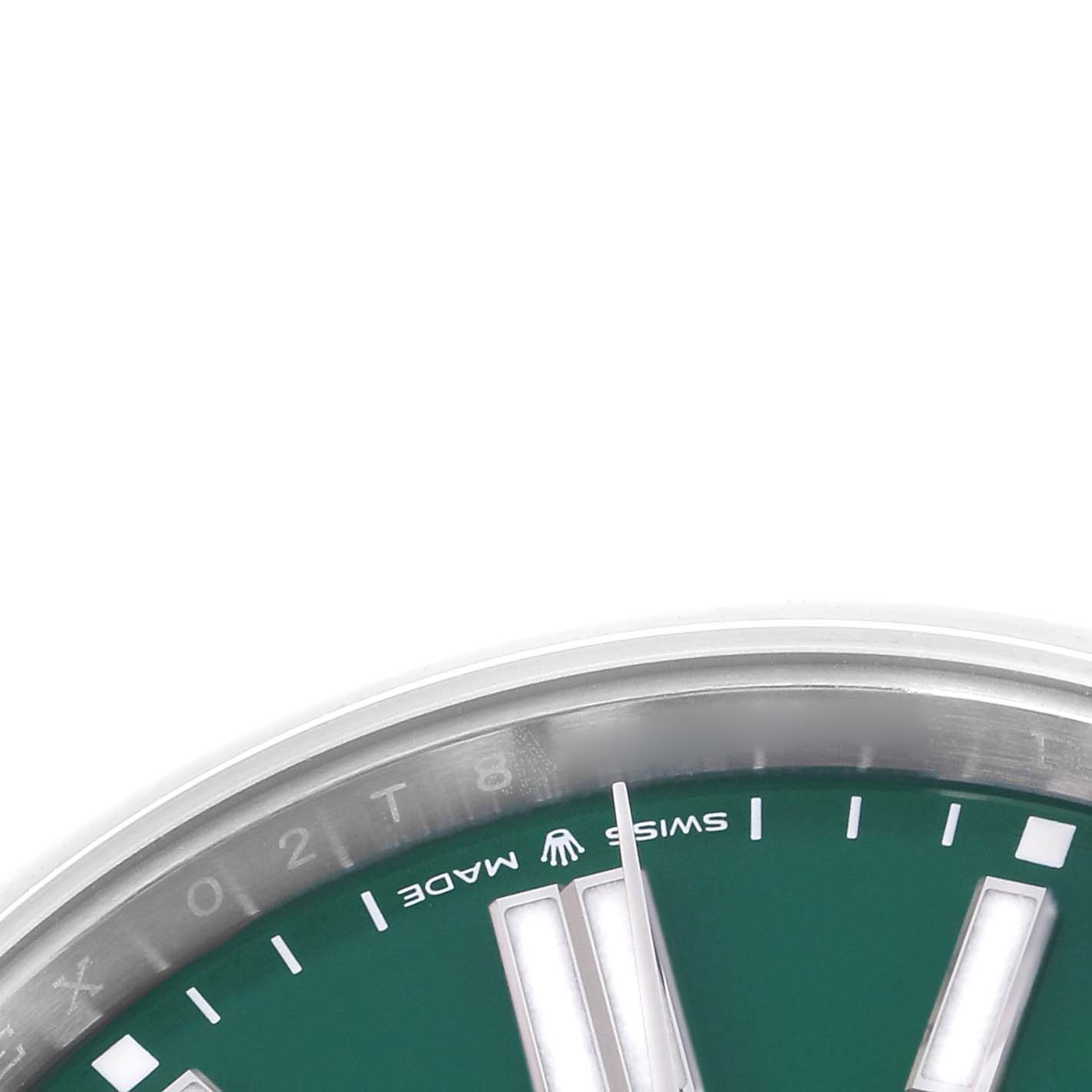 The image shows a close-up of the dial's lower section of the Rolex Oyster Perpetual model 124300, highlighting the hour markers and "SWISS MADE" text.