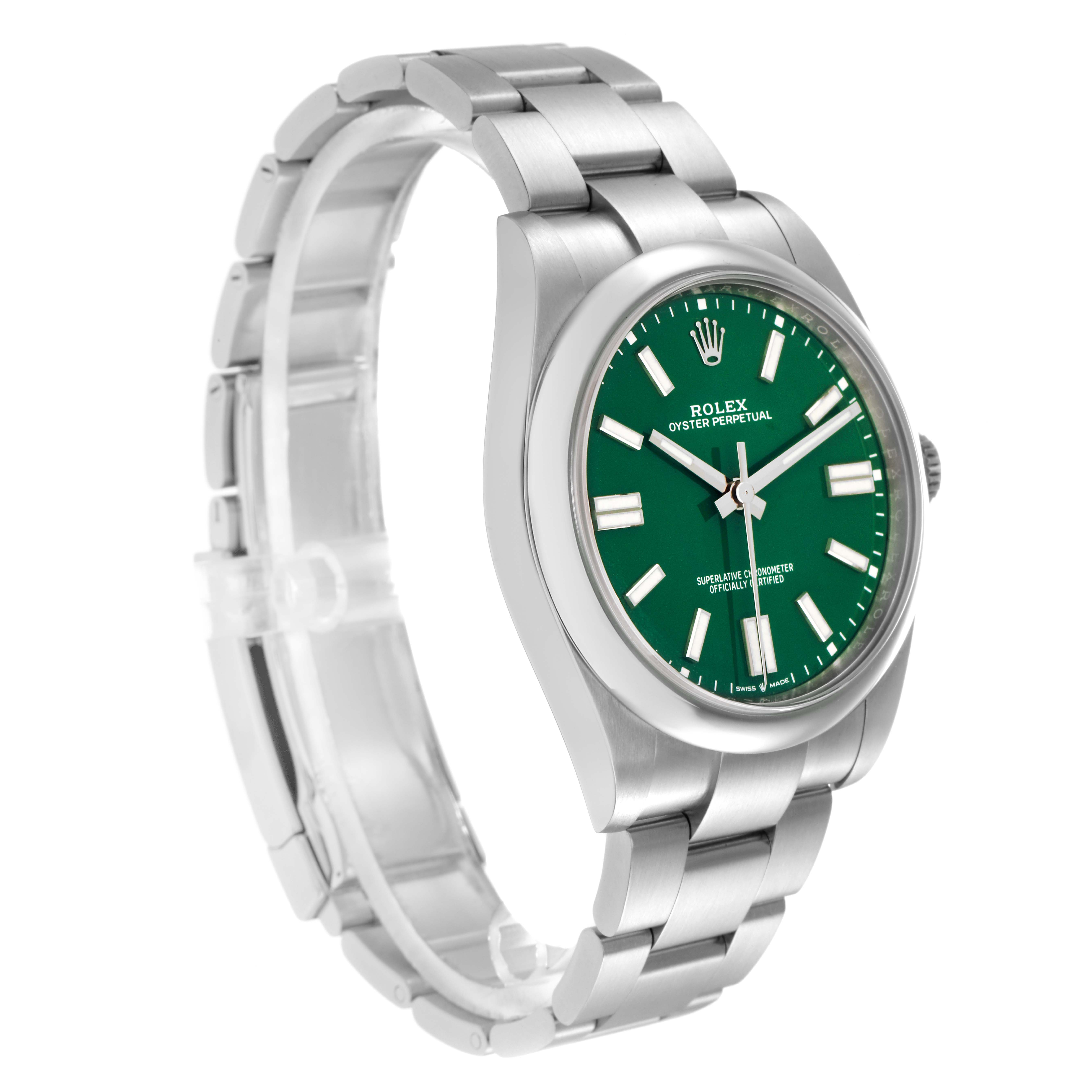 The Rolex Oyster Perpetual model 124300 is shown from a side angle, displaying its green dial, stainless steel case, and bracelet.