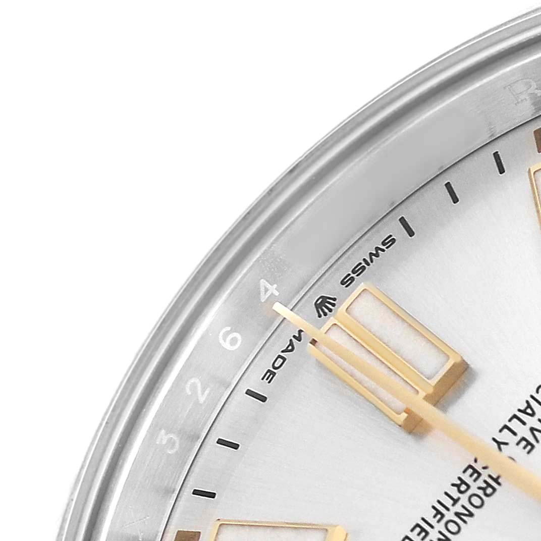 The image shows a close-up of the dial and bezel of the Rolex Oyster Perpetual 124300 Men's Stainless Steel Silver Dial watch, highlighting indices and text details.