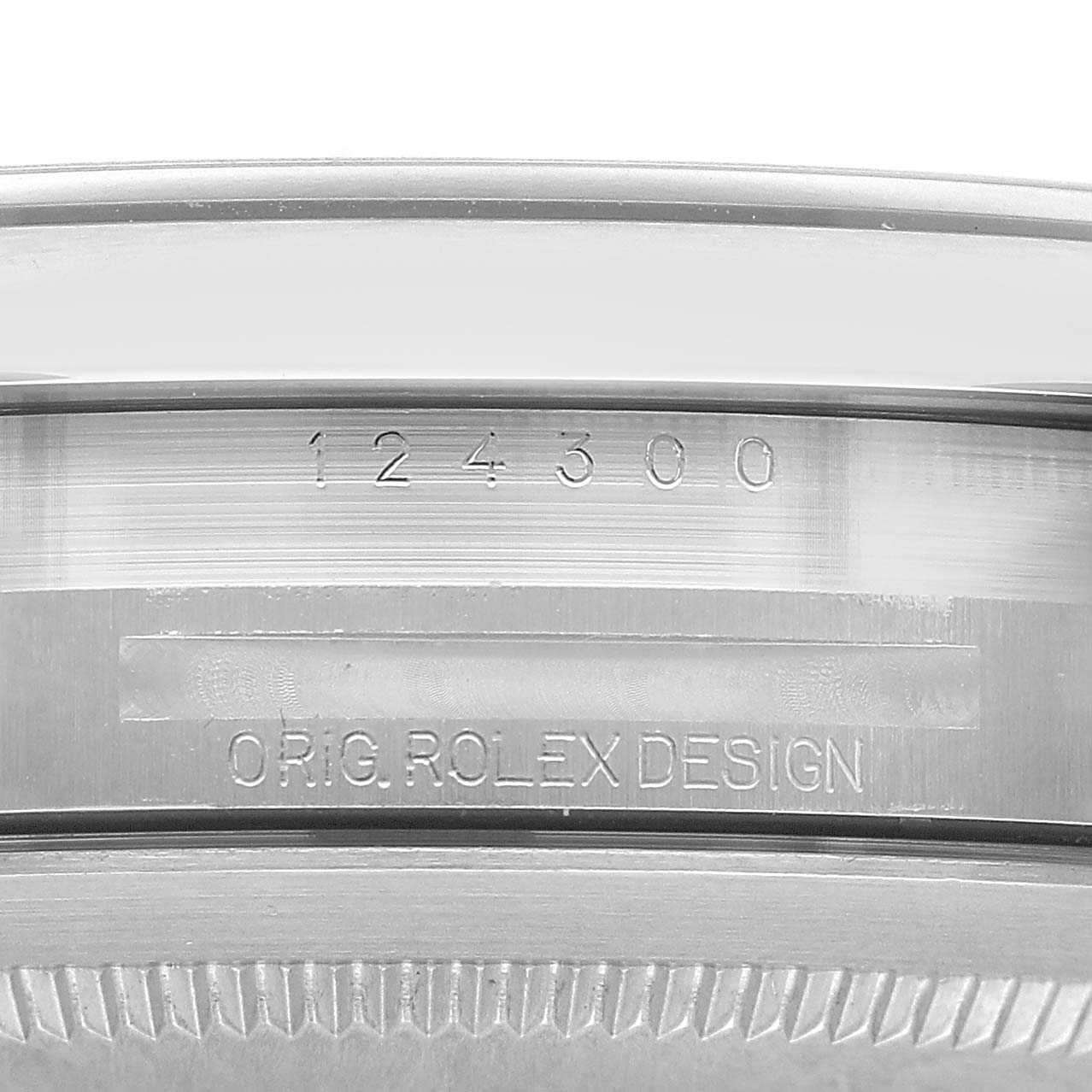 The image shows the case side of the Rolex Oyster Perpetual 124300 Men's Stainless Steel Silver Dial, highlighting the engraved model number and design text.