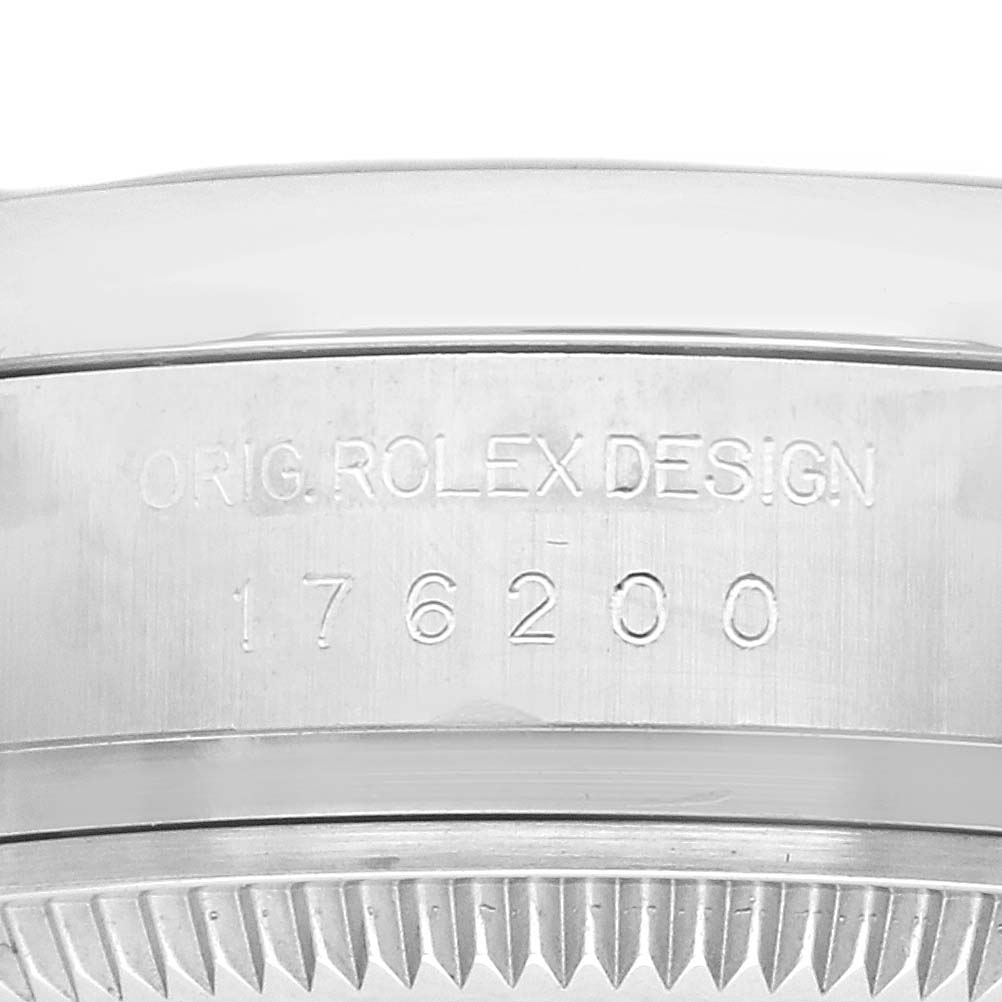 The image shows a close-up of the case side of the Rolex Oyster Perpetual model 176200, focusing on its engraved model number and original design text.