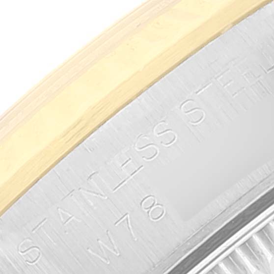 The image shows a close-up angle of the bezel and part of the case with engravings on a Rolex Oyster Perpetual 67193 Women's Steel and Gold (two tone) Champagne Dial 67193 Women's Steel and Gold (two tone) Champagne Dial watch.