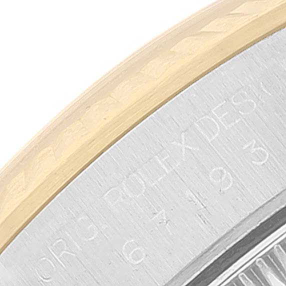 The image shows a close-up of the edge of the bezel and part of the case back of a Rolex Oyster Perpetual 67193 Women's Steel and Gold (two tone) Champagne Dial 67193 Women's Steel and Gold (two tone) Champagne Dial watch.