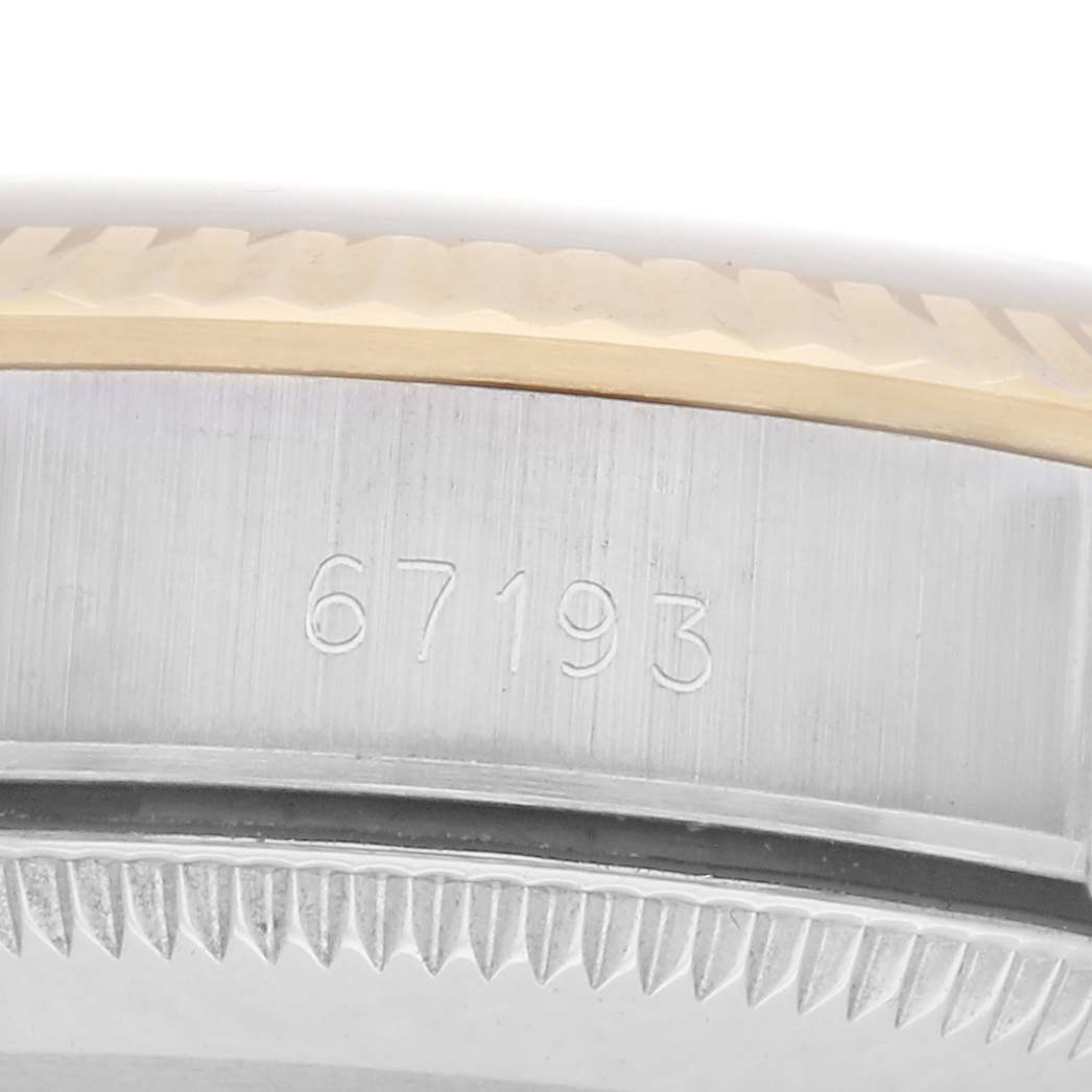 The image shows a close-up of the case side of a Rolex Oyster Perpetual, model number 67193, highlighting the engraved model number and part of the bezel.