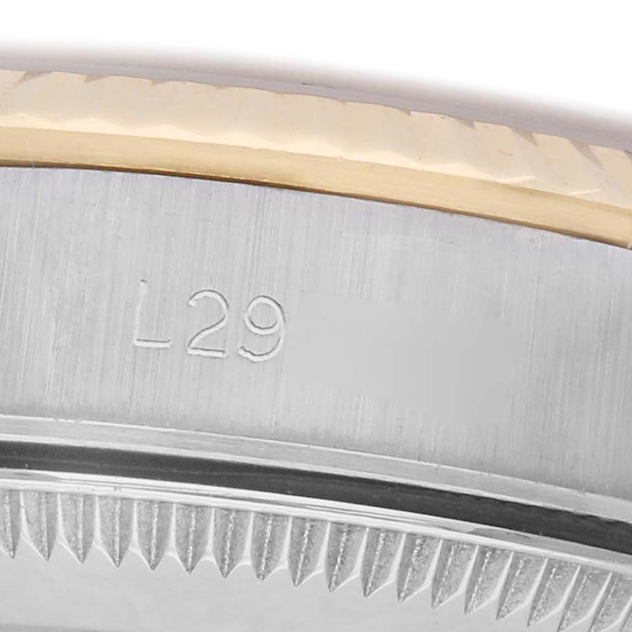 The image shows a close-up of the side of a Rolex Oyster Perpetual watch, model number 67193, focusing on the gold and silver-toned bezel and engraved serial number.