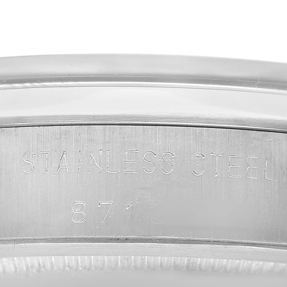 The image shows a close-up of the engraved stainless steel case of a Rolex Date 6694 Men's Stainless Steel Silver Dial model.