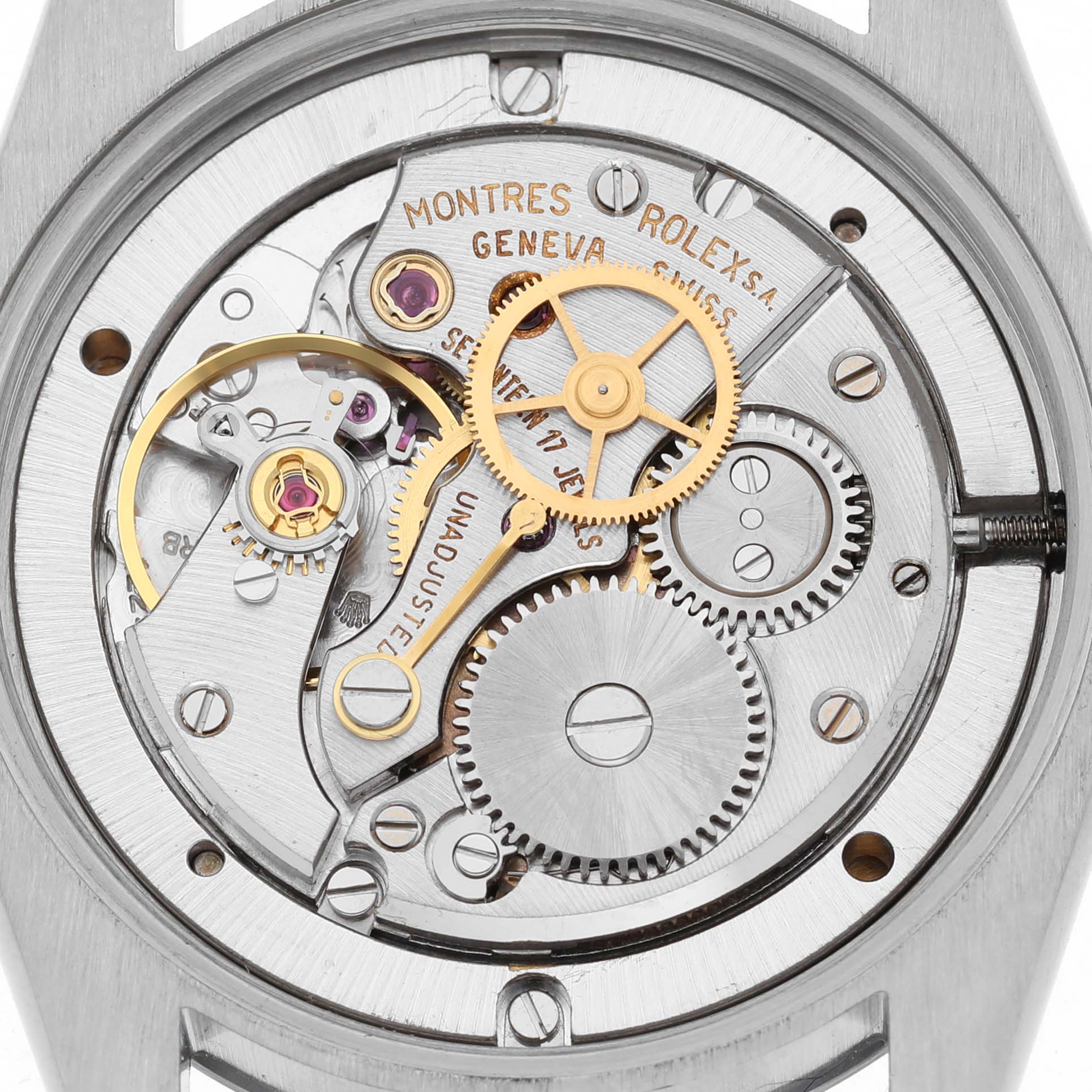 This image shows the inner mechanical movement of a Rolex Date 6694 Men's Stainless Steel Silver Dial watch from a top-down angle, highlighting gears and jewels.