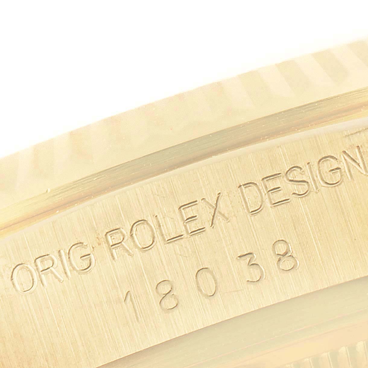This image shows a close-up view of the case side of a Rolex President 18038 Men's Yellow Gold Champagne Dial 18038 Men's Yellow Gold Champagne Dial model, featuring its model number and "Orig Rolex Design" engraving.