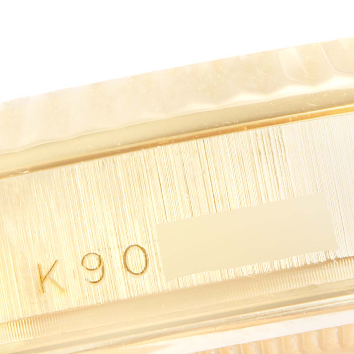 This is a close-up view of the engraved serial number on the side of the Rolex President 118238 Men's Yellow Gold Blue Dial 118238 Men's Yellow Gold Blue Dial model watch case.