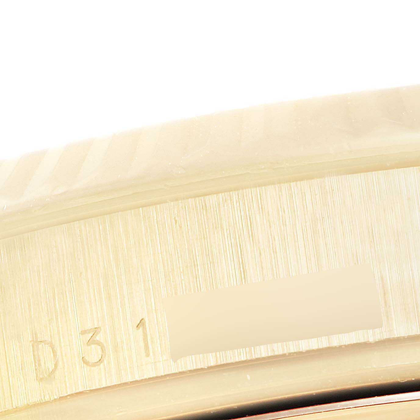 The image shows a close-up of the engraved serial number on the case of a Rolex President 118238 Men
s Yellow Gold Silver Dial 118238 Men
s Yellow Gold Silver Dial model watch.