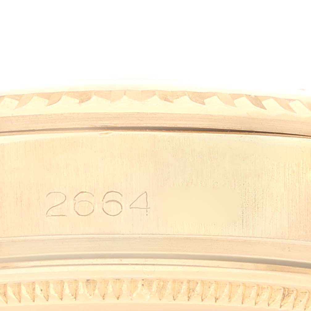 The image shows a close-up of the bezel, serial number, and part of the case of a Rolex Vintage Collection 1803 Men
s Yellow Gold Silver Dial 1803 Men
s Yellow Gold Silver Dial watch.