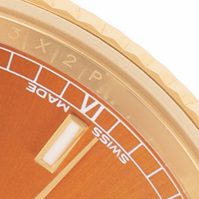 This is a close-up of the dial and bezel of a Rolex President 118138 Men's Yellow Gold Orange Dial model watch, showing the hour markers and part of the chapter ring.
